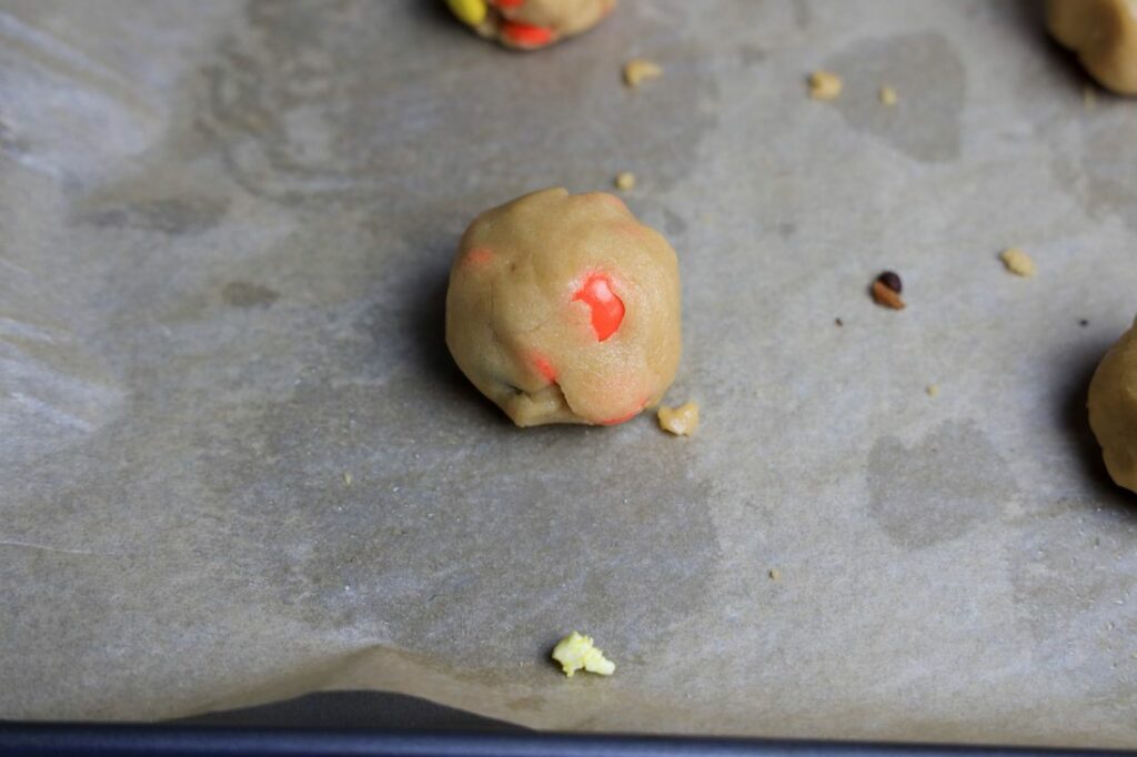 Dough ball on a baking sheet lined with parchment paper.