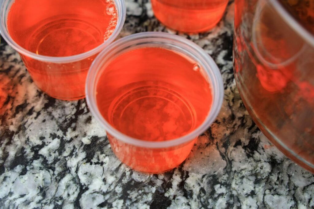 Orange jello in 5.5 oz size cleat cups.