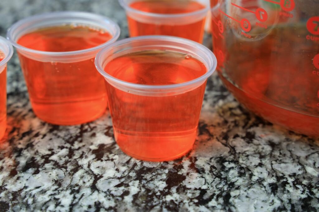 Orange jello in 5.5 oz size cleat cups.