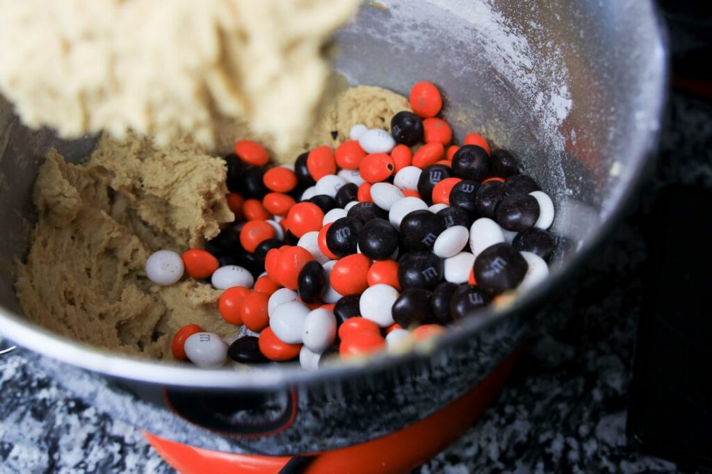 Peanut butter cookie mixture with the cookies and screeem M&M's.