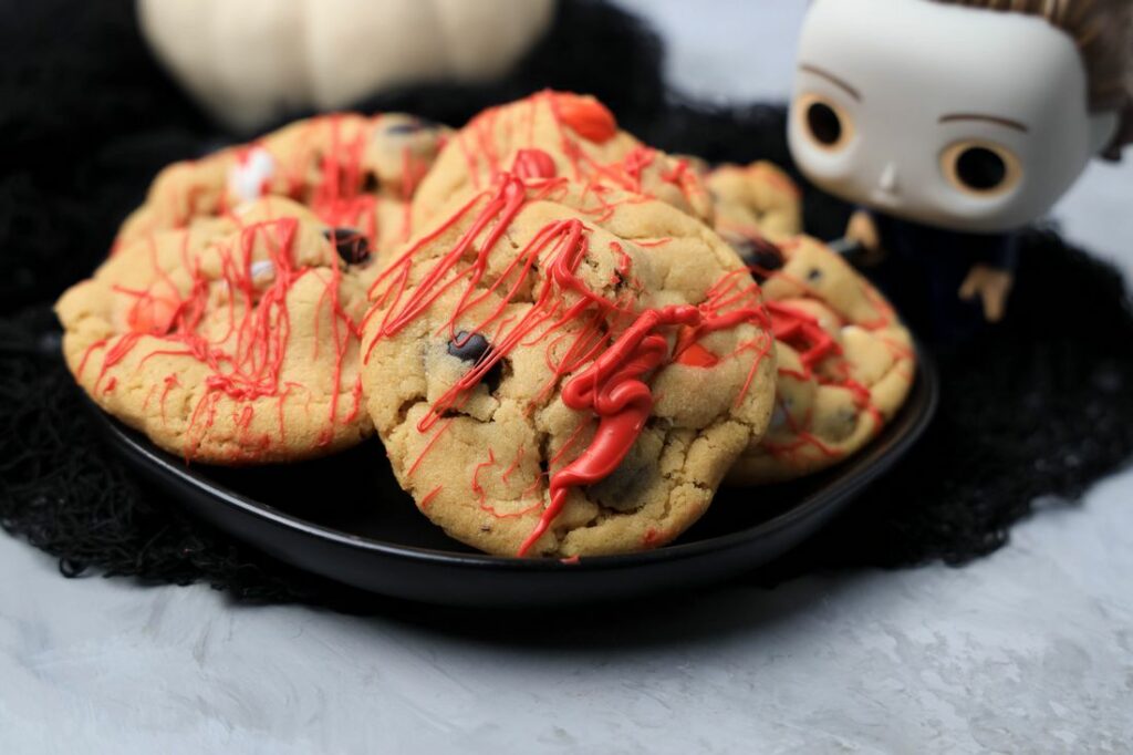 Halloween Michael Myers Bloody Cookies on a black plate with funko pop michael myers in the back.