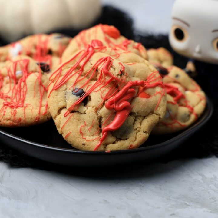 Halloween Michael Myers Bloody Cookies on a black plate with funko pop michael myers in the back.