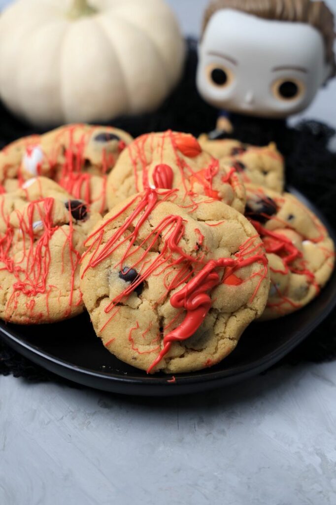 Halloween Michael Myers Bloody Cookies on a black plate with funko pop michael myers in the back.