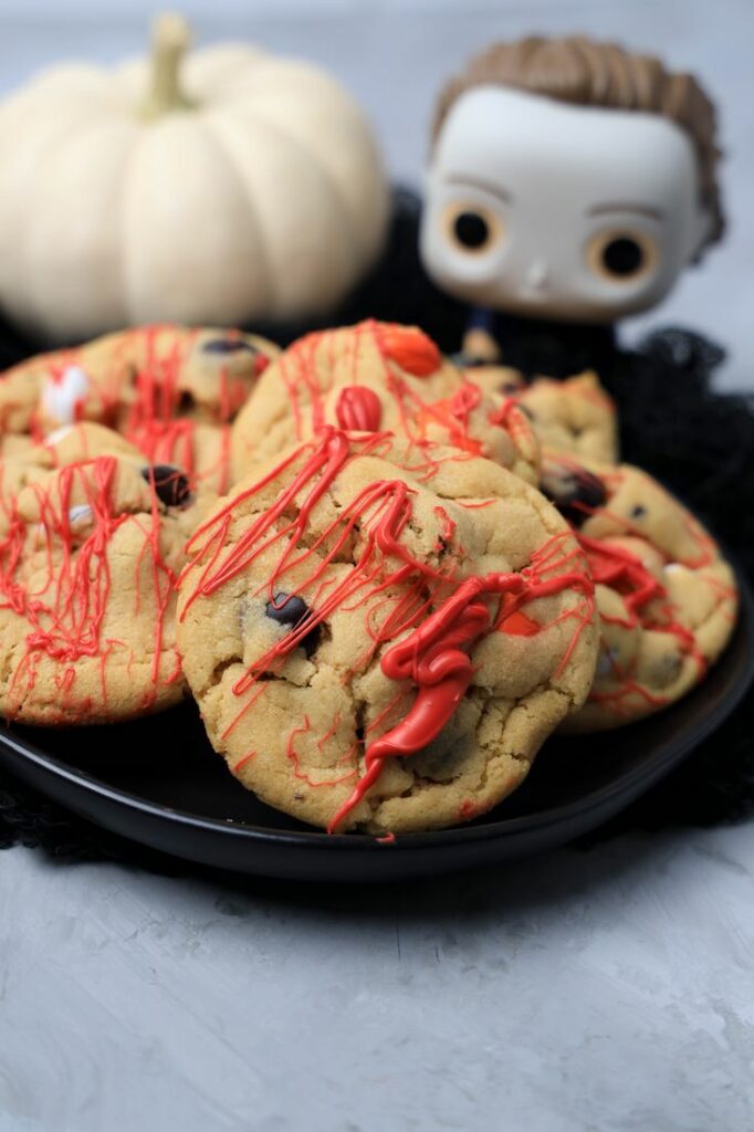 Halloween Michael Myers Bloody Cookies on a black plate with funko pop michael myers in the back.