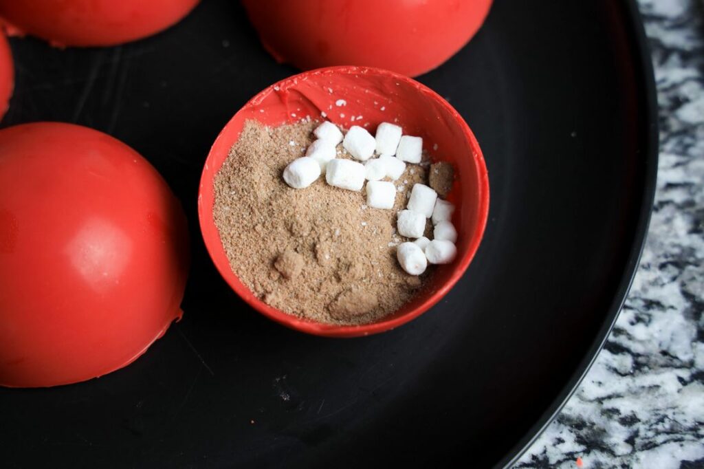 Red candy hot chocolate bomb with swiss miss and marshmallow bits