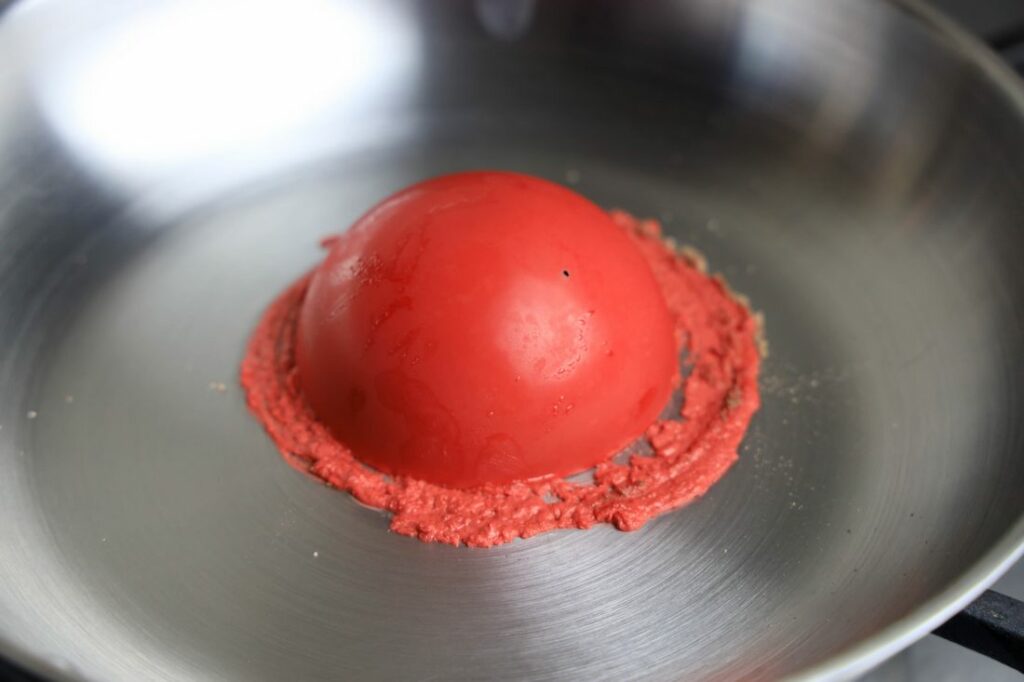 Red hot chocolate bomb side upside down in pan