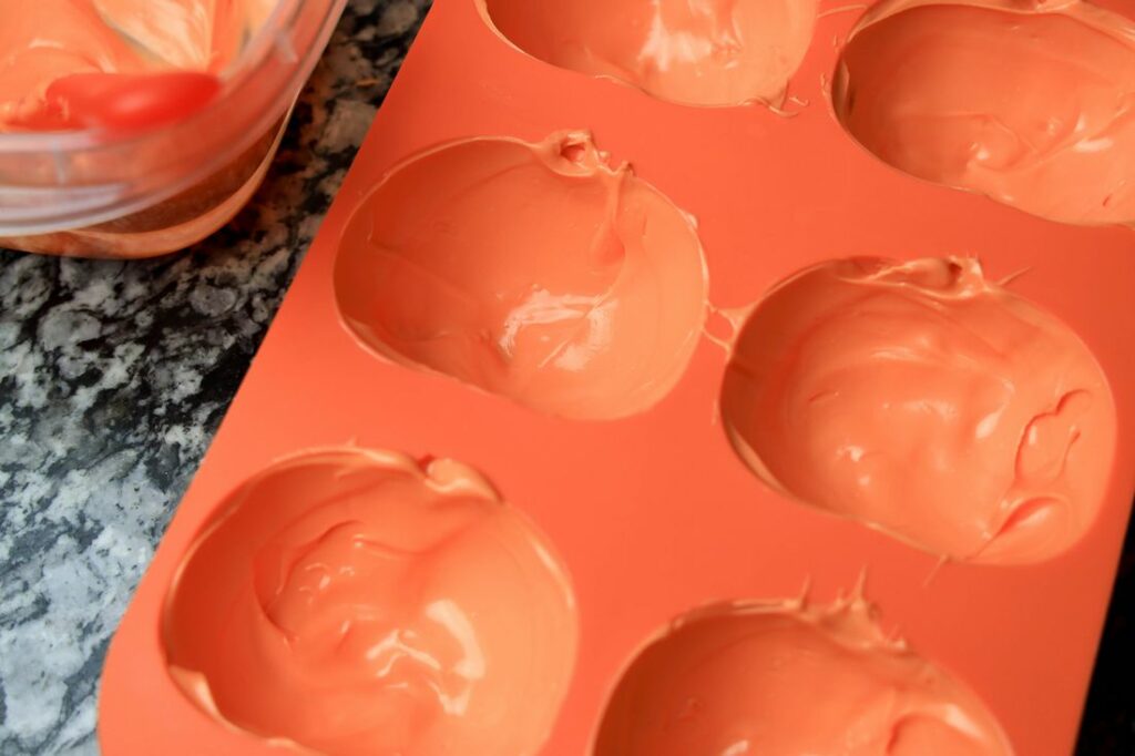 Pumpkin mold coated with orange candy melts.