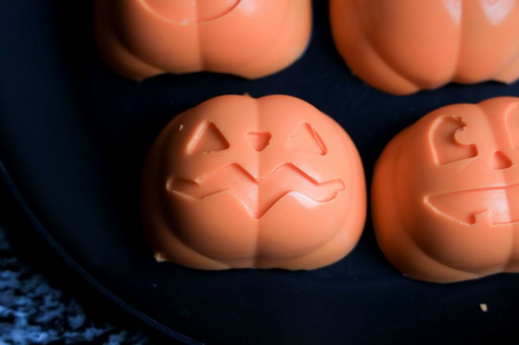 Orange pumpkin chocolate domes removed from the mold.