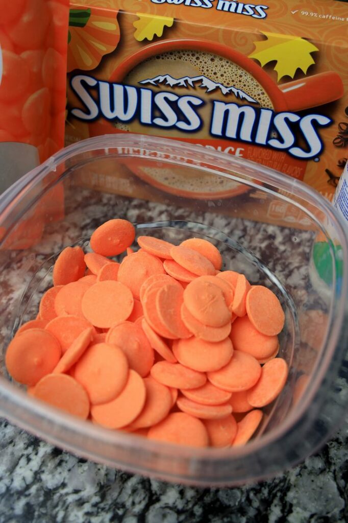 Orange candy melts inside a bowl.