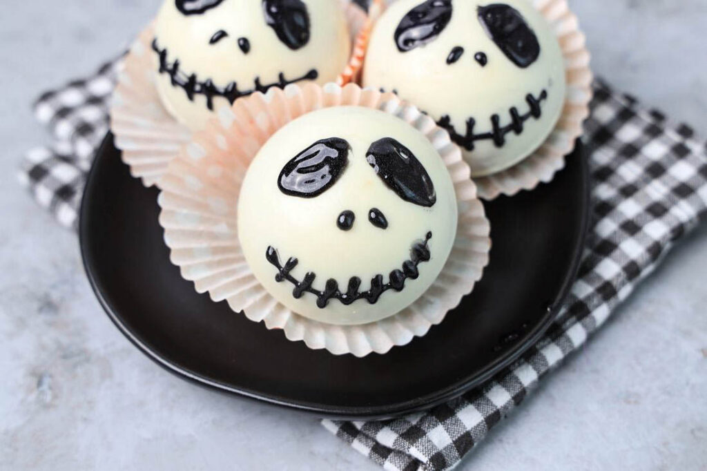 White hot chocolate bomb with Jack Skellington face drawn on.