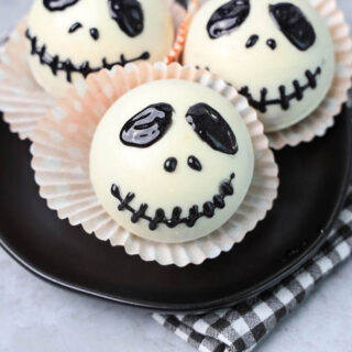 White hot chocolate bomb with Jack Skellington face drawn on.