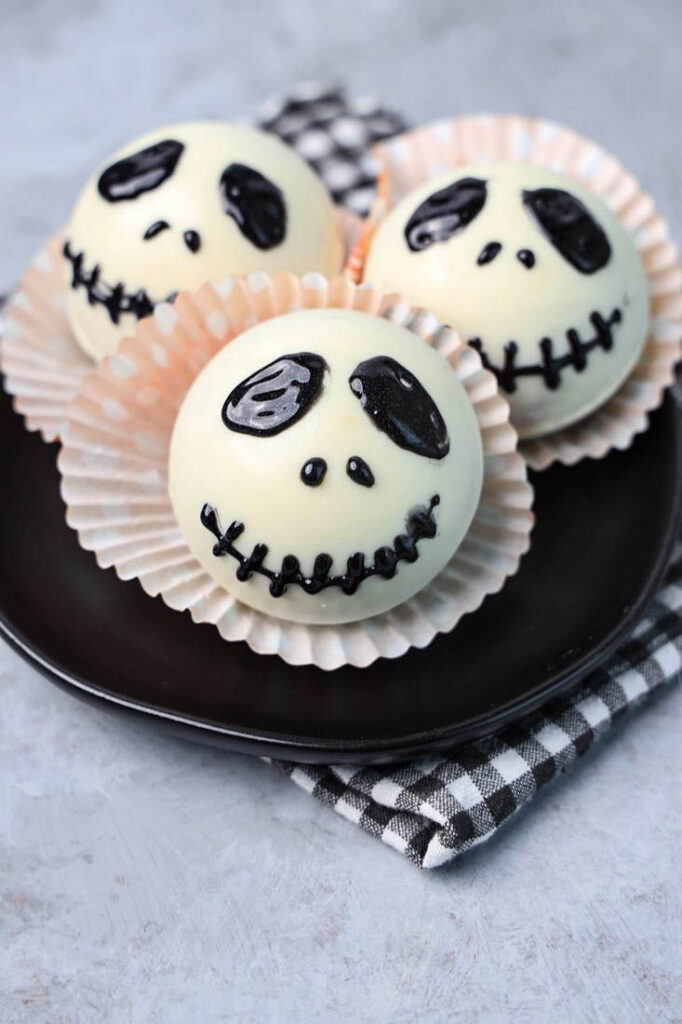 White hot chocolate bomb with Jack Skellington face drawn on.