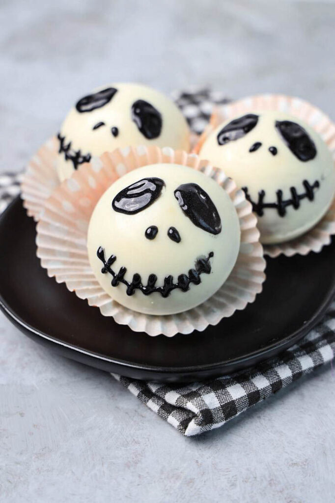 White hot chocolate bomb with Jack Skellington face drawn on.