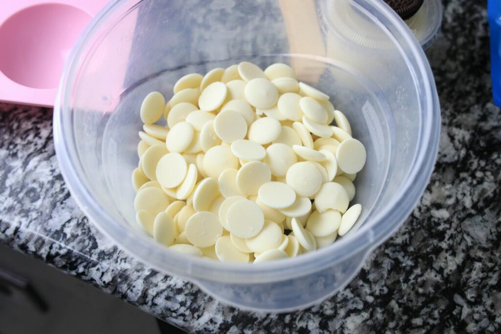 White chocolate melting wafers in a bowl.