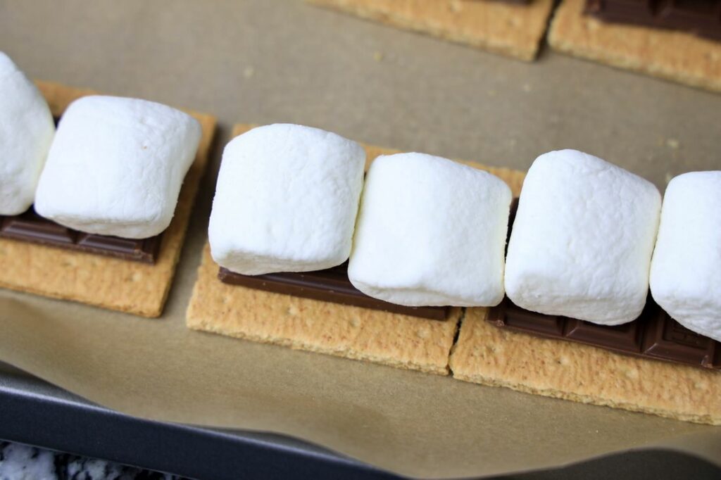 Marshmallows on top of chocolate on graham crackers.