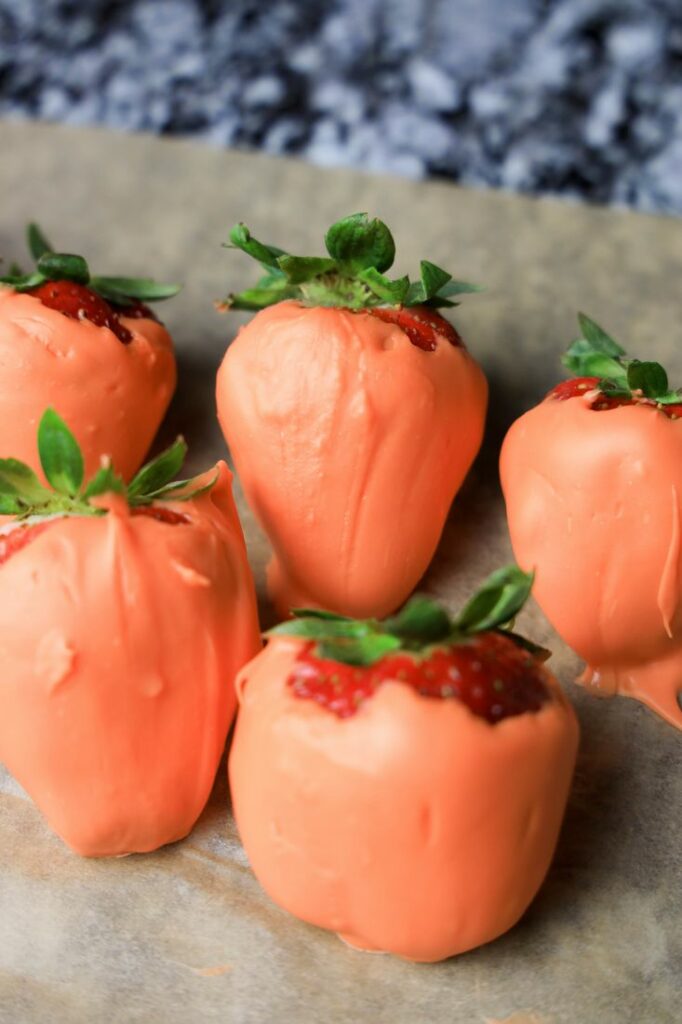 Candy melt orange covered strawberries.