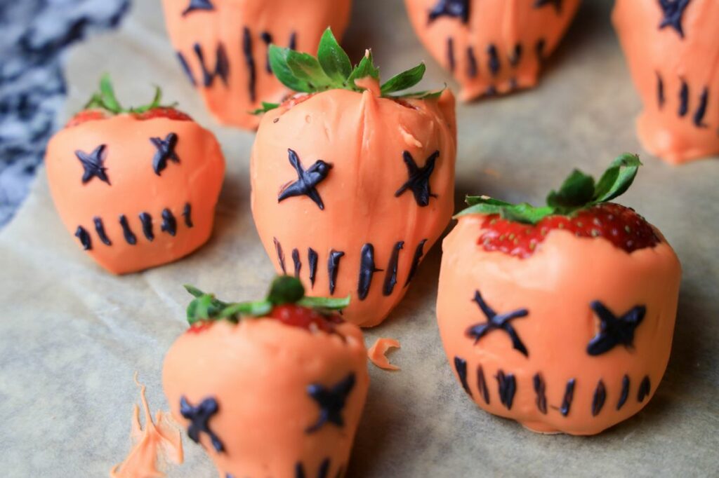 Orange covered pumpkins with black eyes as X's and stick mouths.