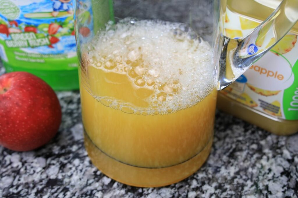 Pineapple juice in a glass pitcher.