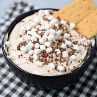 Hot Chocolate dip made with whipped topping and topped with marshmallow bits and chocolate curls.