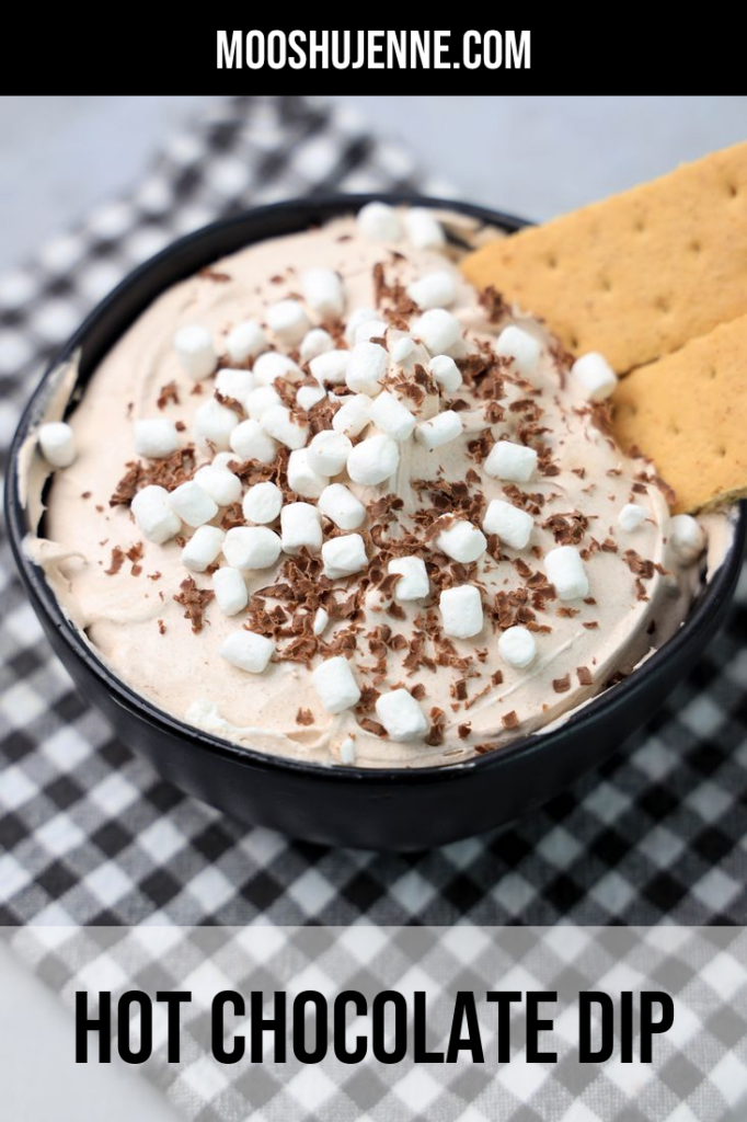 Hot Chocolate dip made with whipped topping and topped with marshmallow bits and chocolate curls.