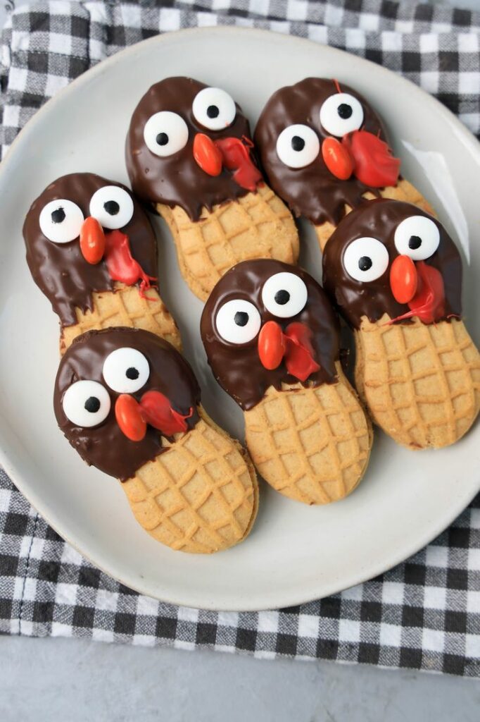 Nutter butter cookies dipped in chocolate with eyes and nose added to look like a turkey.