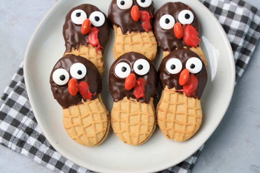 Nutter butter cookies dipped in chocolate with eyes and nose added to look like a turkey.