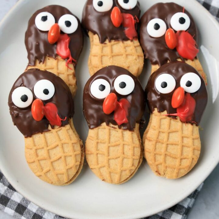 Nutter butter cookies dipped in chocolate with eyes and nose added to look like a turkey.