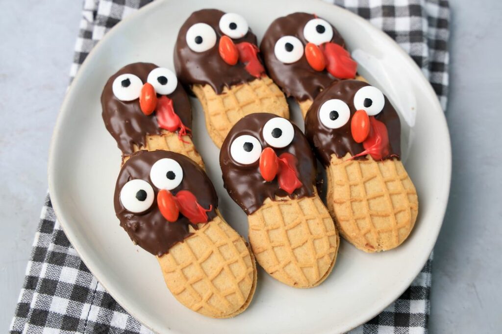 Nutter butter cookies dipped in chocolate with eyes and nose added to look like a turkey.