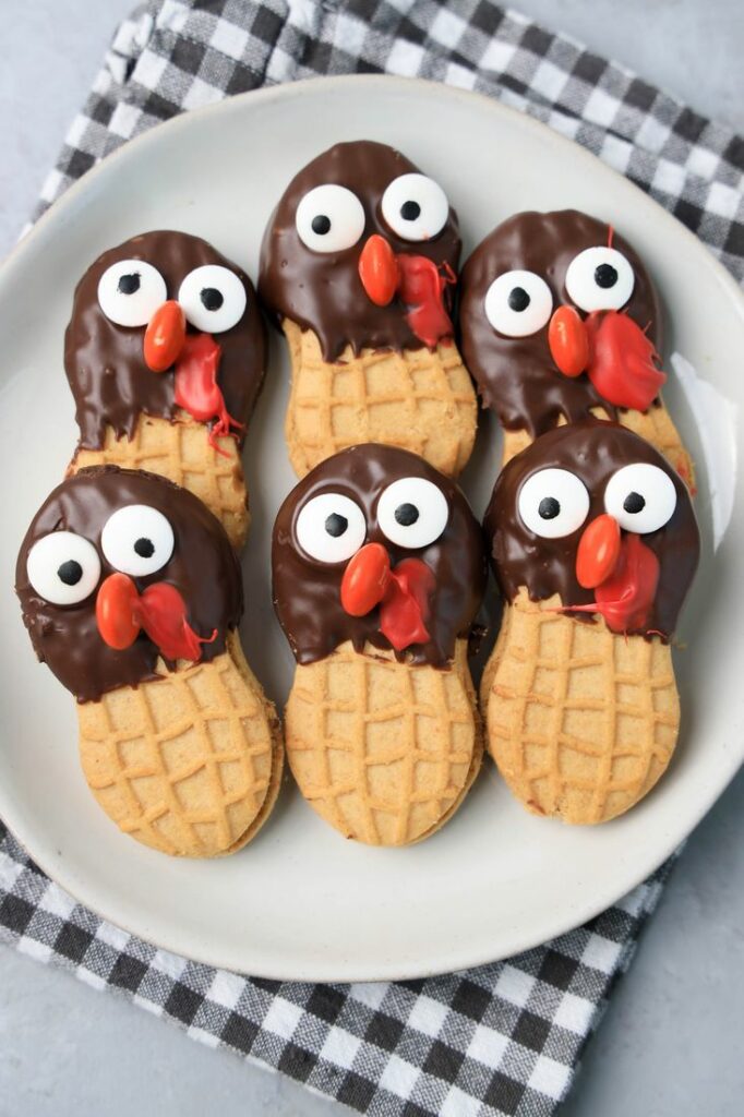 Nutter butter cookies dipped in chocolate with eyes and nose added to look like a turkey.