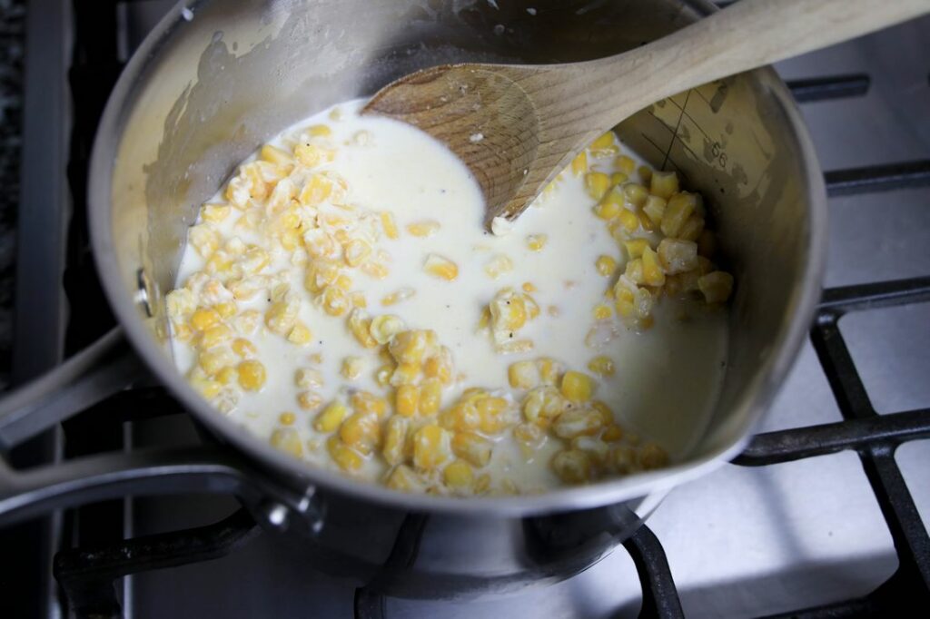 Corn mixture in a pot on the stove.