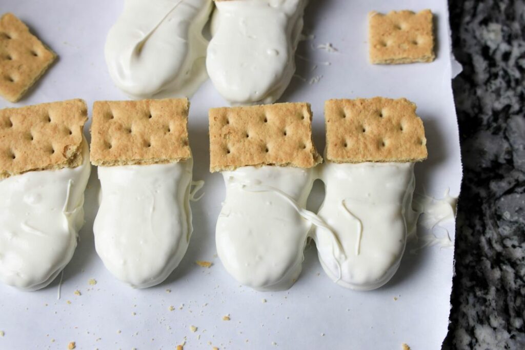 Nutter butters dipped in white chocolate. with graham cracker hats.