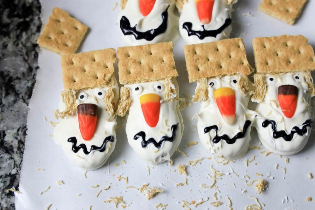 Nutter butters dipped in white chocolate. with graham cracker hats. Drawn on mouth.