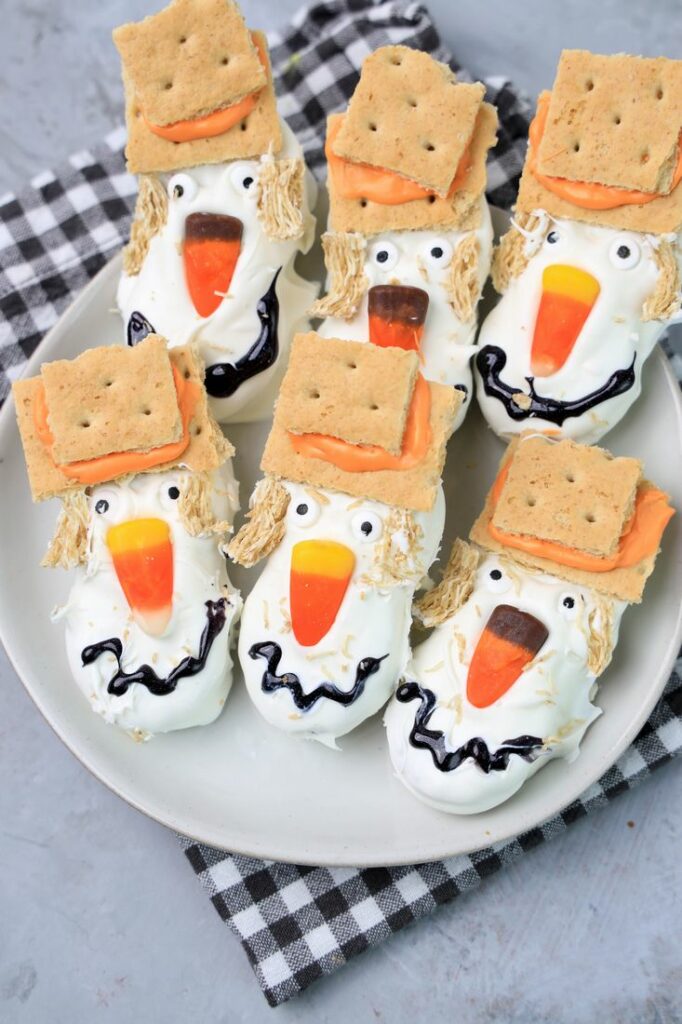 Nutter butters covered in white chocolate with candy corn nose and candy eyes.