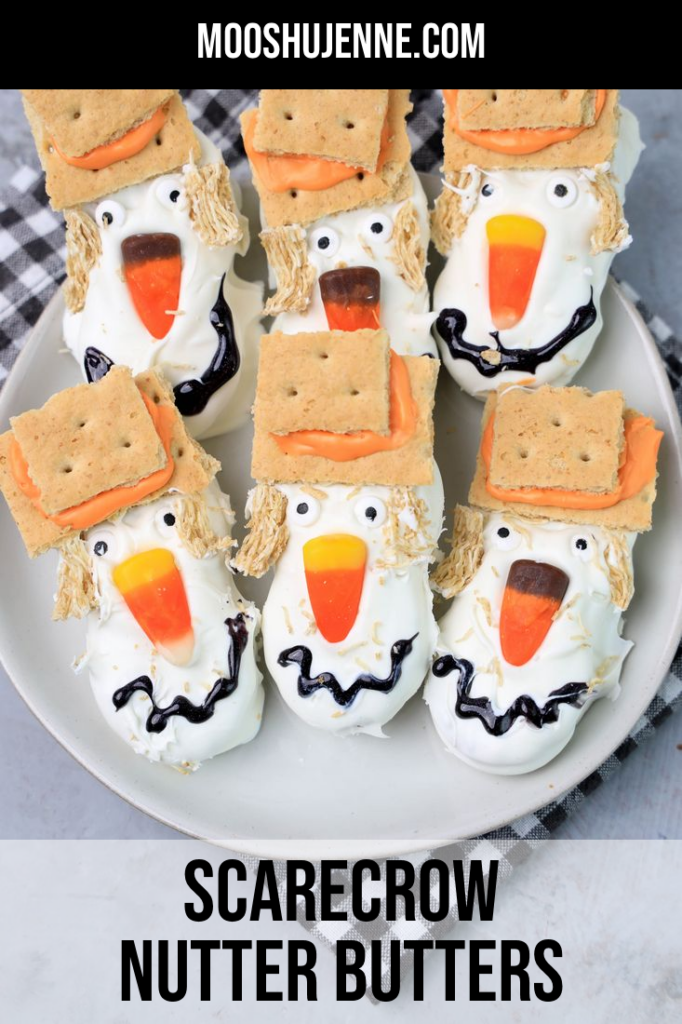 Scarecrow nutter butters with graham cracker hat and candy corn noses.