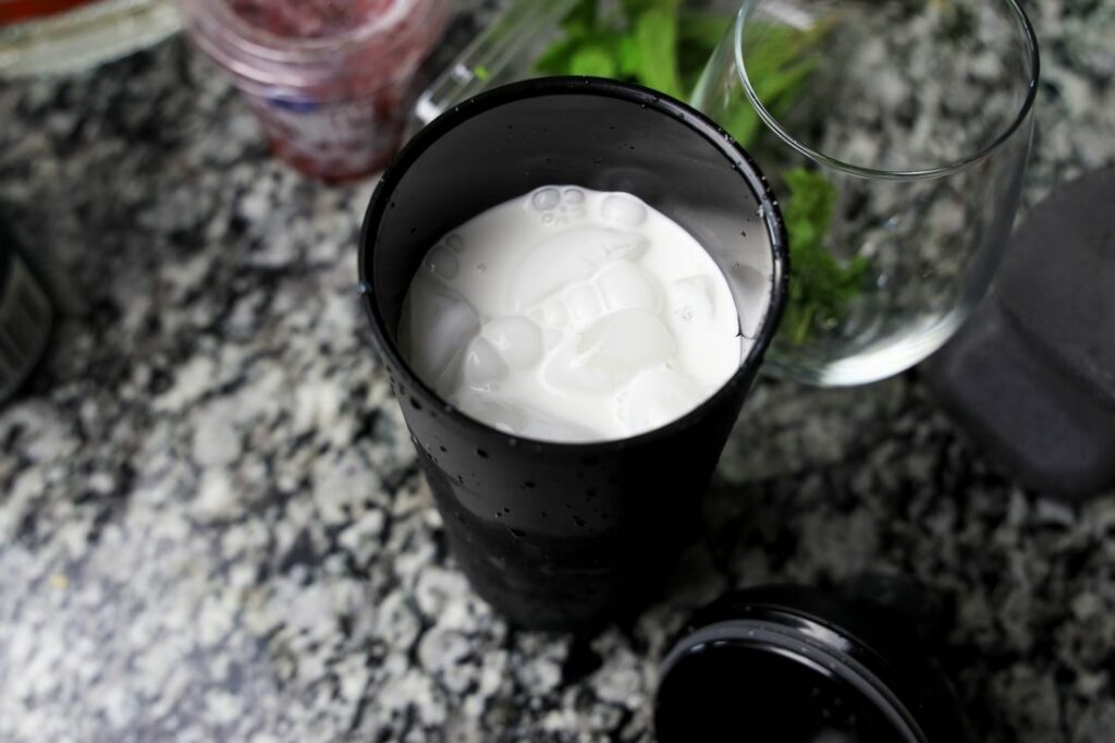 Rum mixture in the shaker on the counter top.