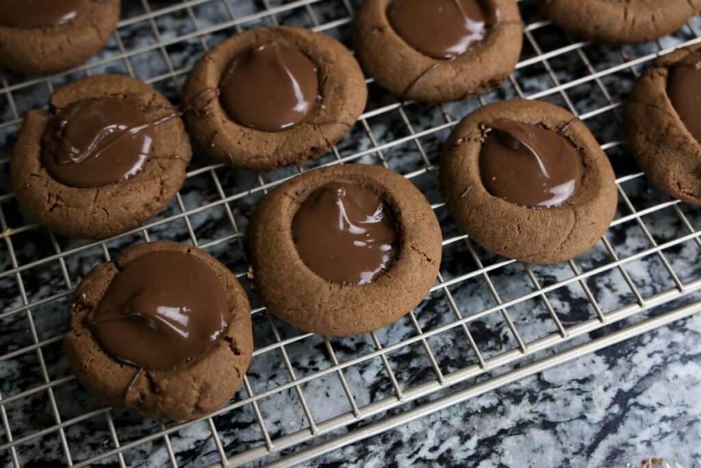 Chocolate thumbprint cookies filled with melted chocolate.