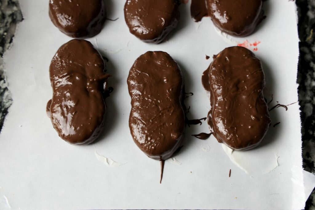 Dipped nutter butter in dark chocolate on a piece of freezer paper.