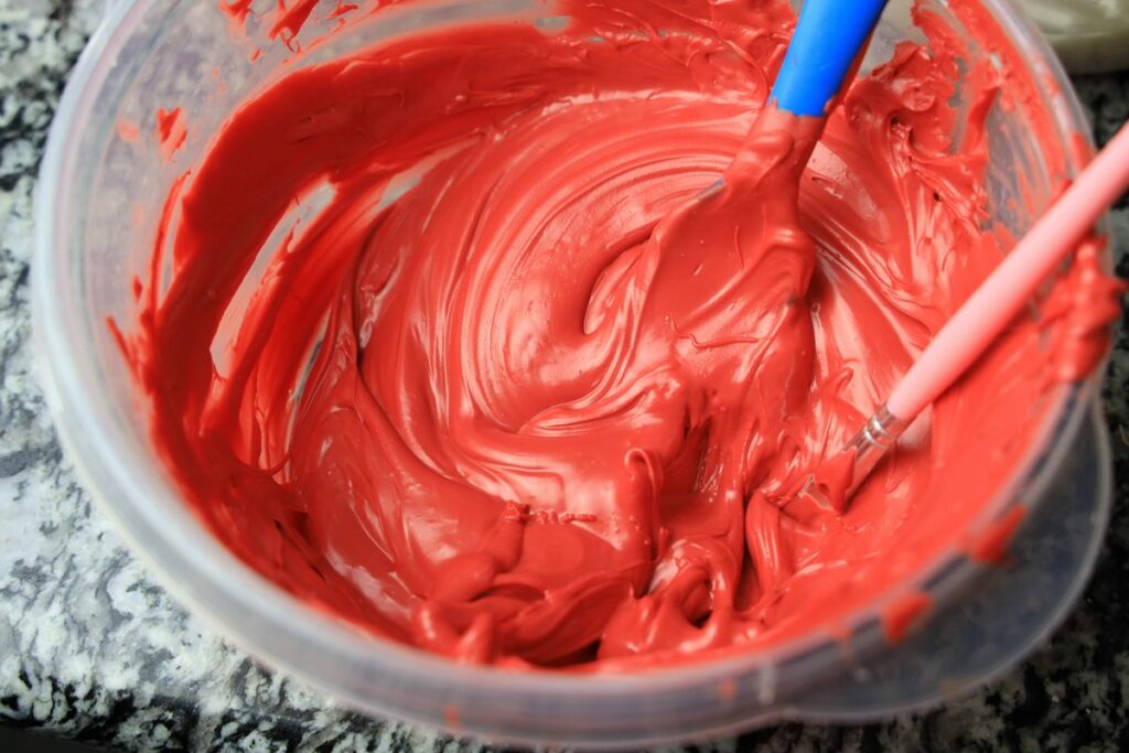 Red melted candy melts in a microwave safe bowl.