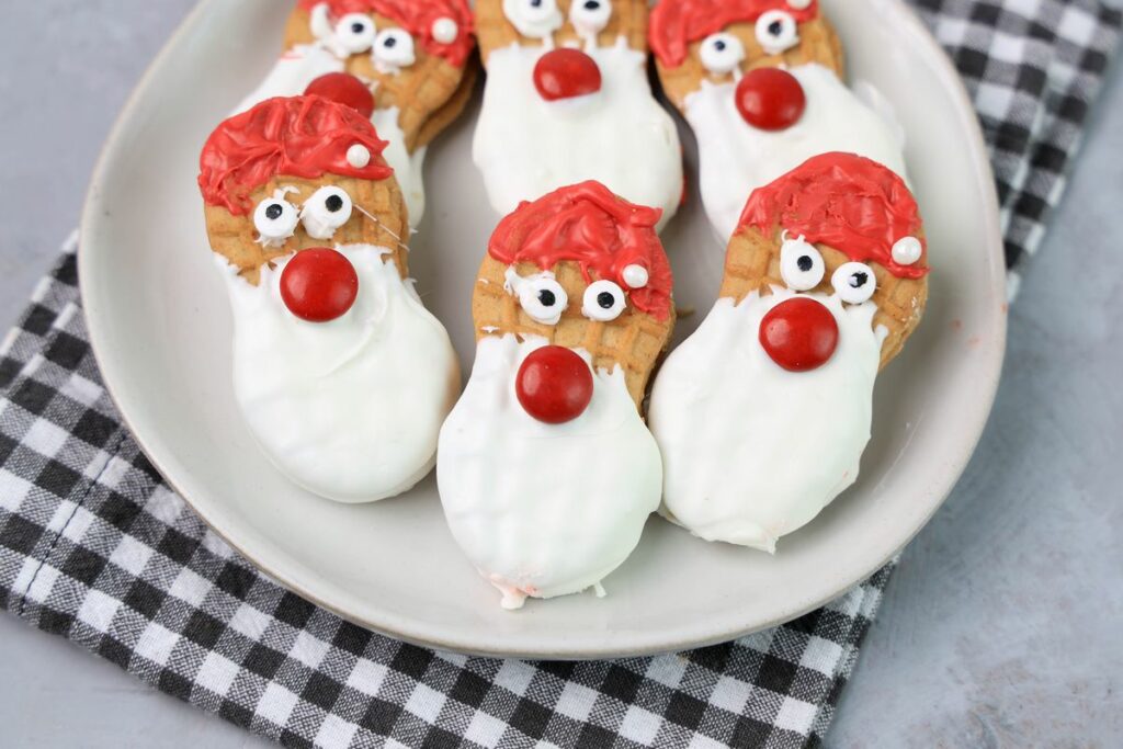 Santa nutter butters on a white plate with a gray plaid napkin.