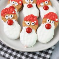 Santa nutter butters on a white plate with a gray plaid napkin.