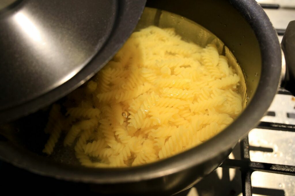 Boiling pasta in a pasta pot.