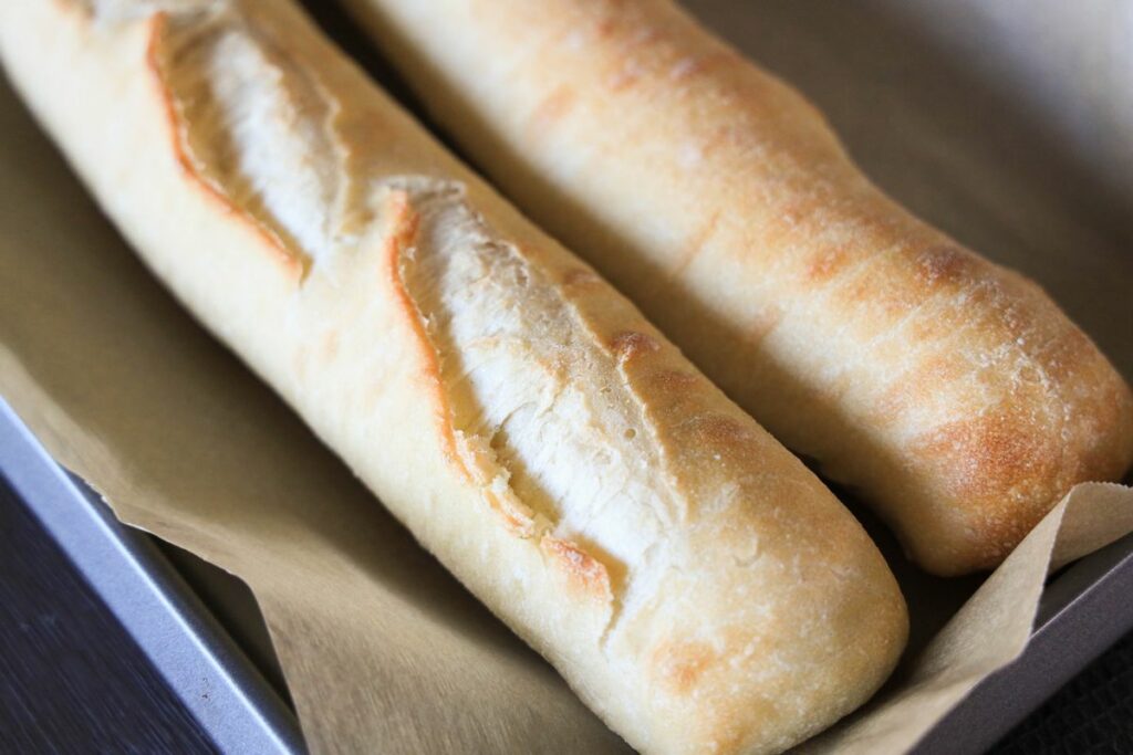 Baguette bread on a baking sheet.