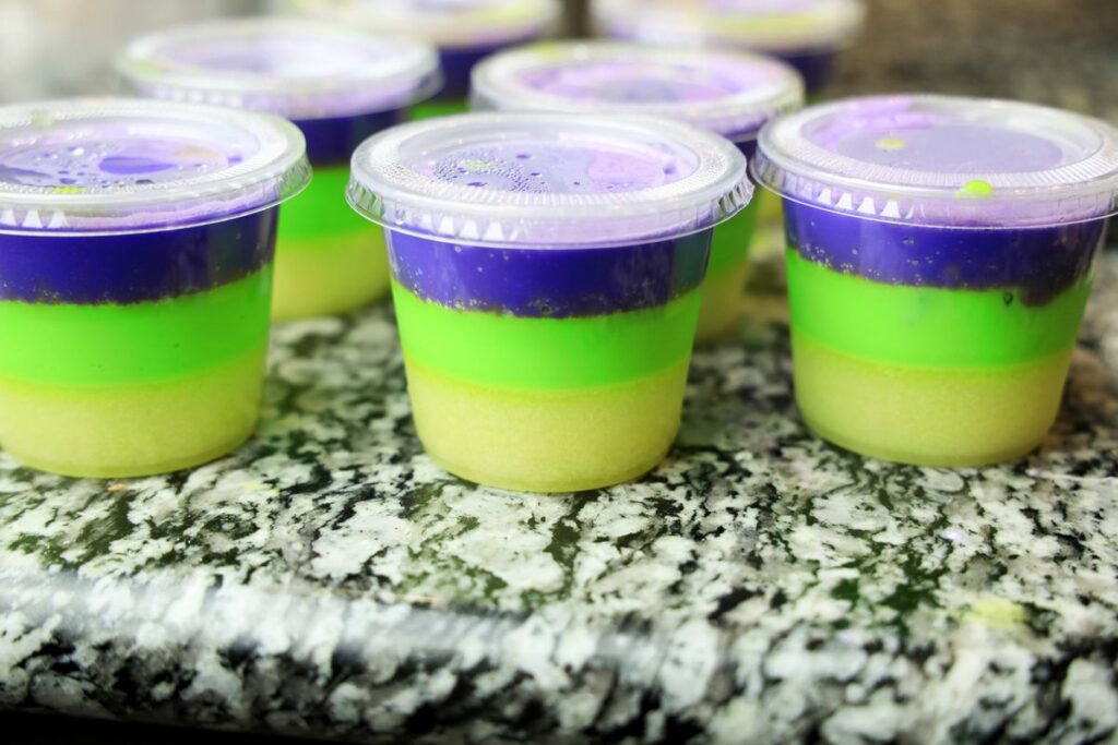 Jello shots with all layered colors for Mardi Gras.