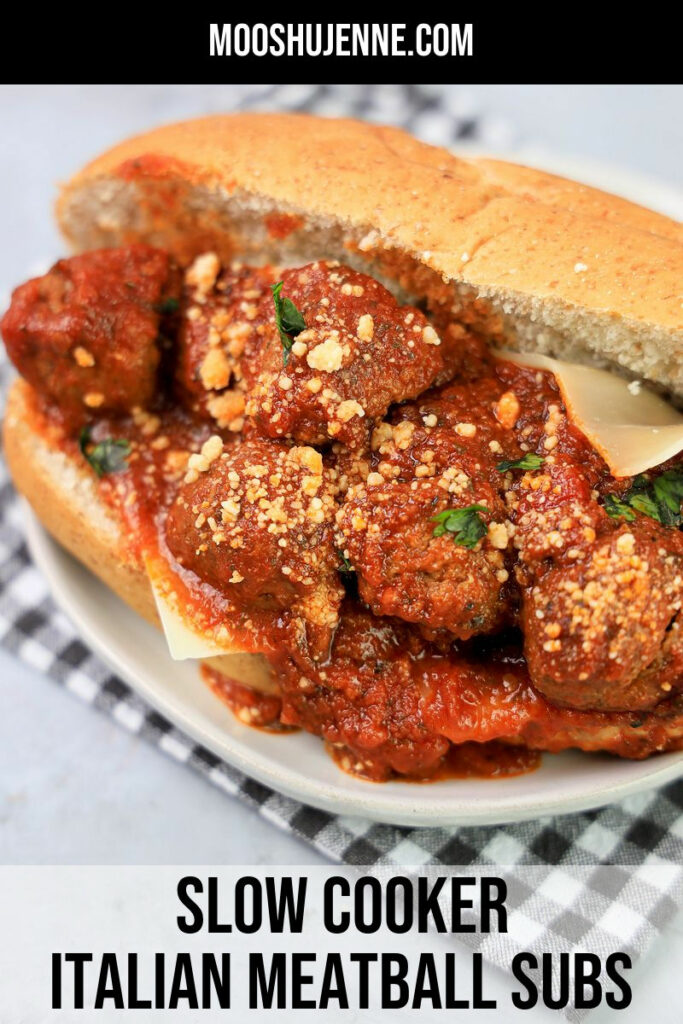 Slow Cooker Italian Meatball Subs on a white plate with a gray plaid napkin on a faux concrete backdrop.