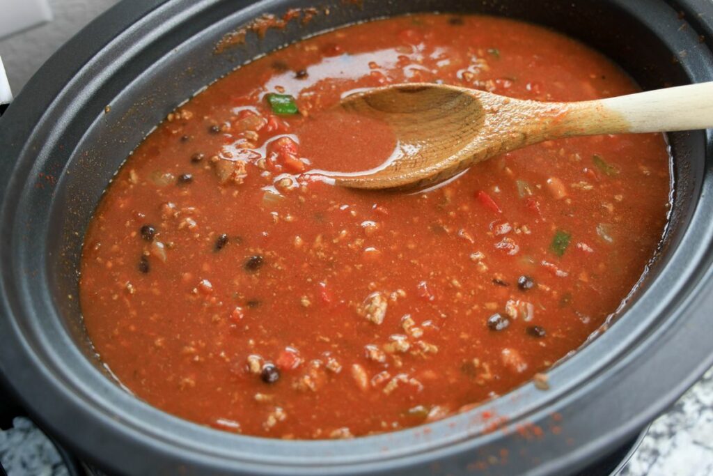 Beef broth and tomato sauce in the slow cooker.