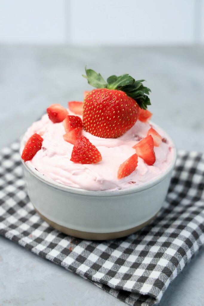 Strawberry cheesecake dip is sweet and creamy fruit based dip. This no bake appetizer is perfect for movie night. Made with cool whip, cream cheese, and fresh strawberries.