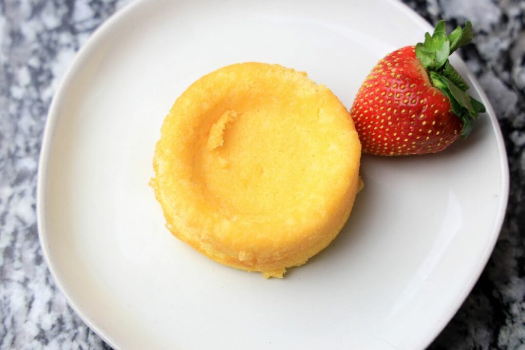 Dessert shell that's made of a sponge cake on a white plate.