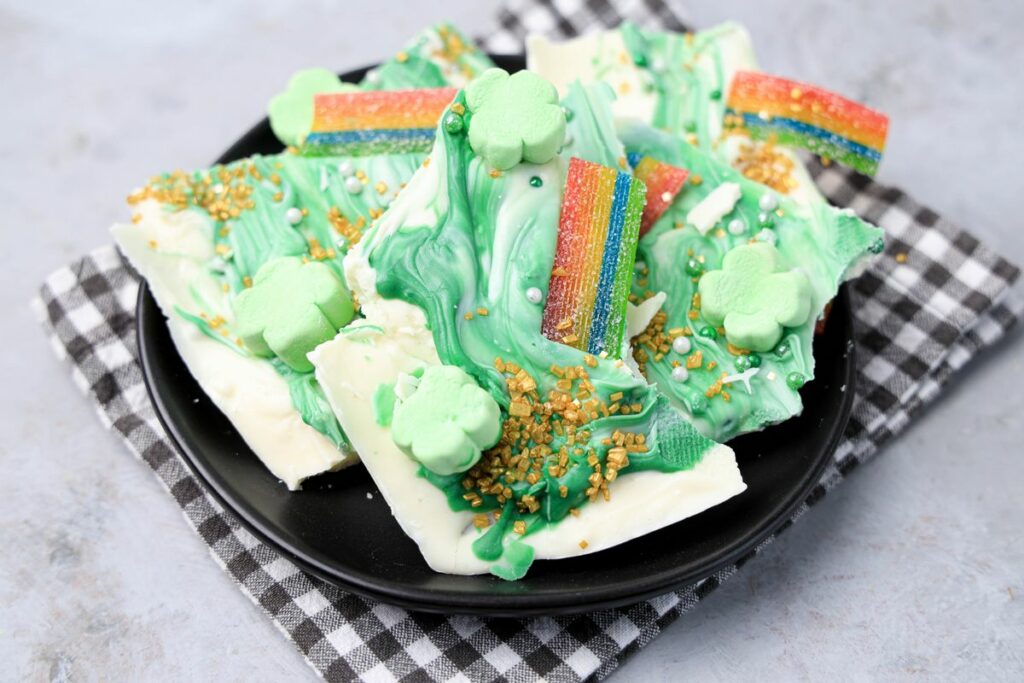 Lucky Leprechaun Bark is a sweet candy bark with rainbow Airhead candy and Lucky Charms marshmallows. Decorated with pearl glitter sprinkles and gold sanding sugar. Perfect for a St. Patrick's Day treat.