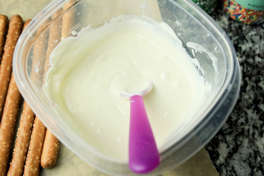 White chocolate wafers melted in a bowl.