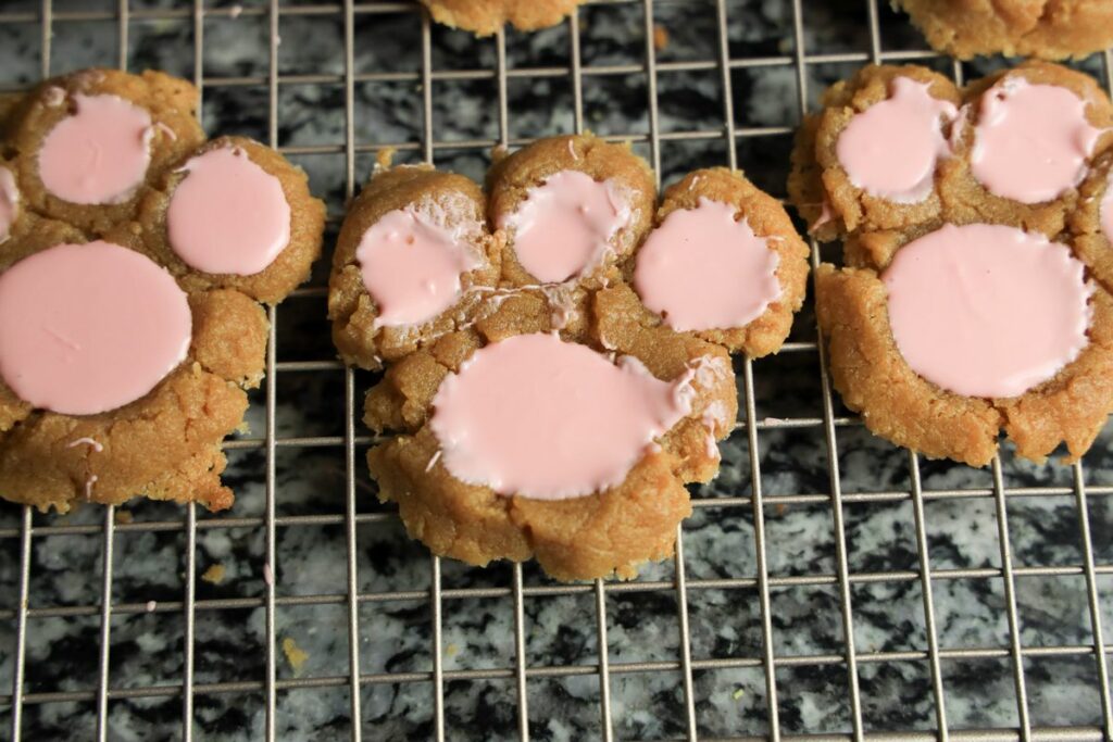 Peanut butter bunny paw cookies on a cookie cooling rack. 